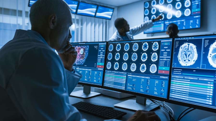 Doctor Examining Brain Scan On Computer