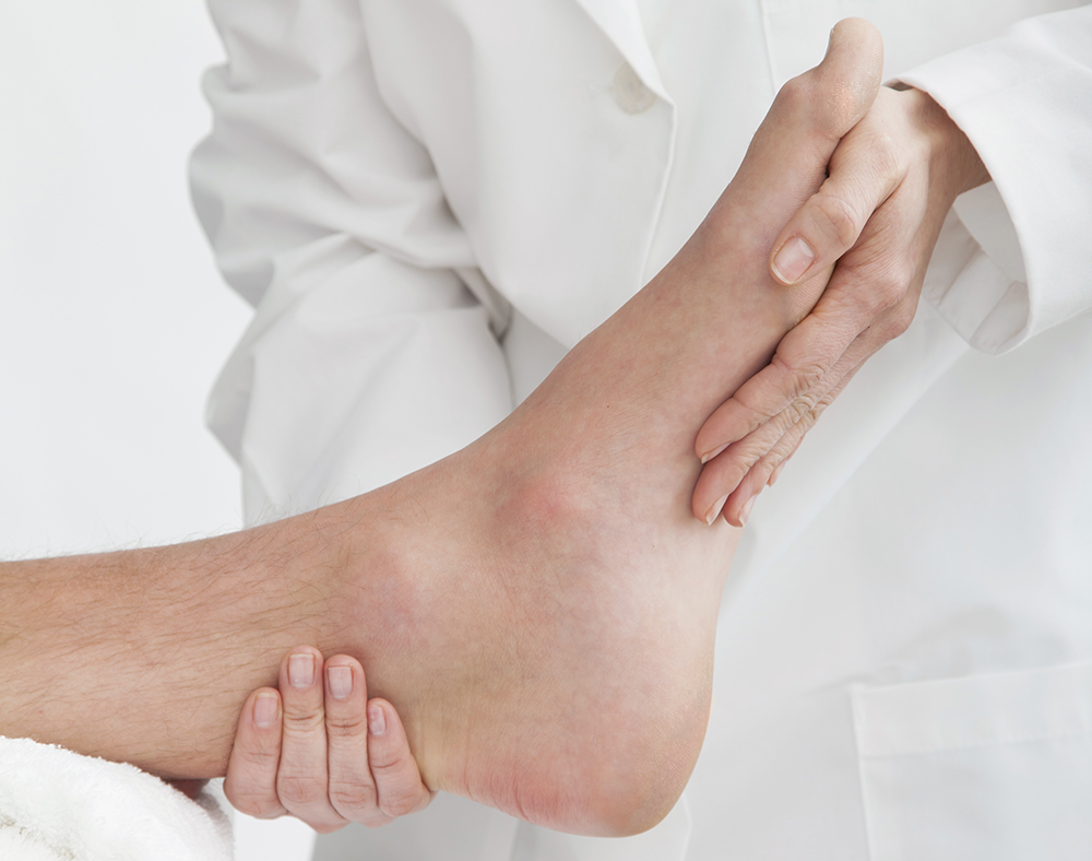 Closeup of Podiatrist's Hands on Patient's Foot