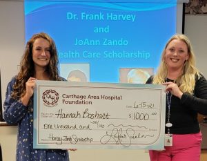 Hannah Boshart accepting check from Carthage Area Hospital