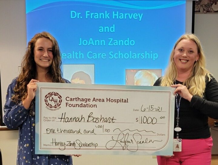 Hannah Boshart accepting check from Carthage Area Hospital