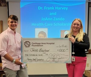 Jacob M. Barber accepting check from Carthage Area Hospital