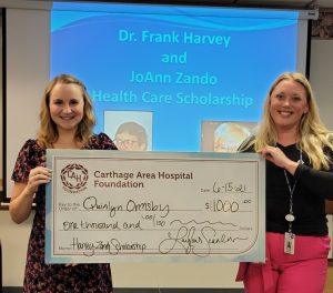 Quinlyn Ormsby accepting check from Carthage Area Hospital