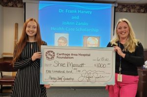 Shae M. Marriott accepting check from Carthage Area Hospital