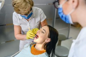 Dentist checking patient mouth