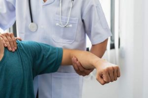 Orthopedist examining patient's shoulder