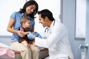 Pediatrician examing baby