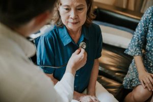 Doctor listening to patient's chest